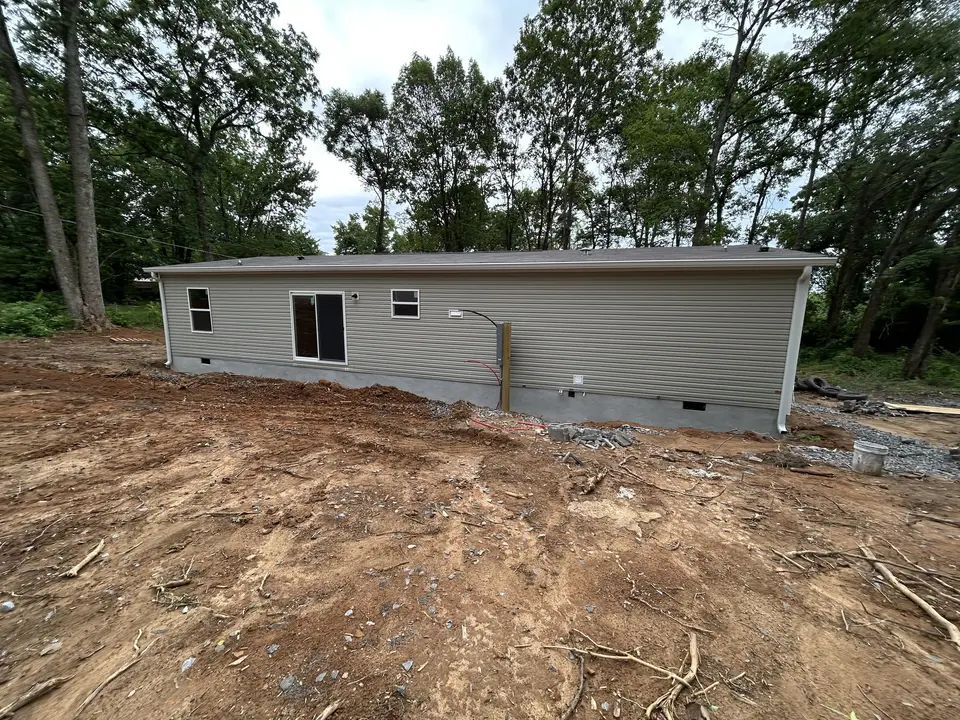 Before: Final grading and gravel drive for a new home