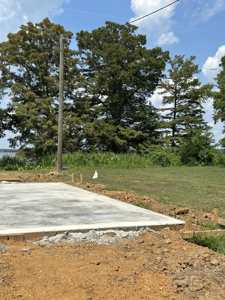 Freshly poured pad, level and square, in an open yard