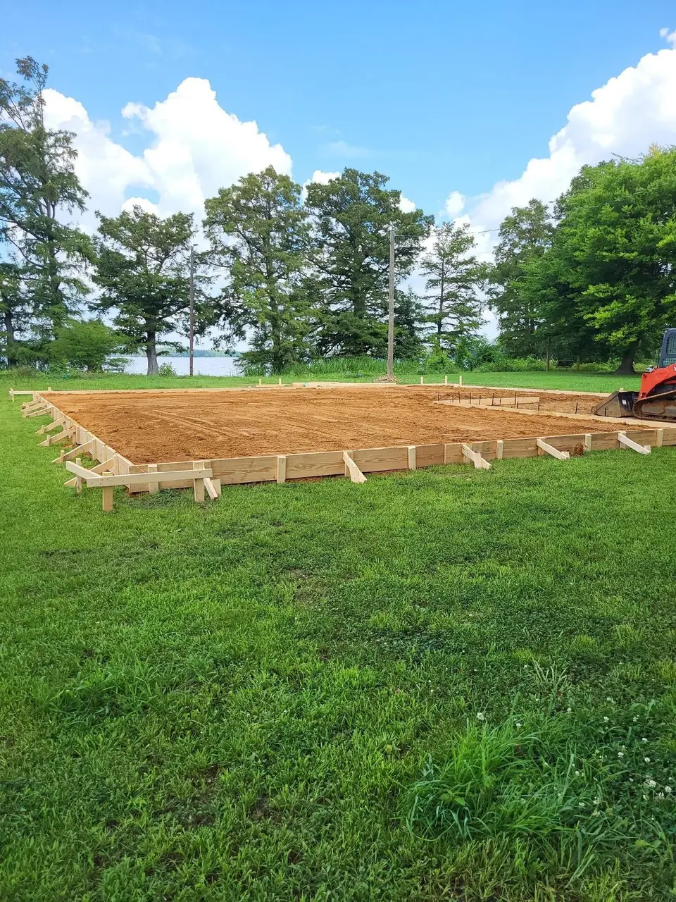 Pad area laid out with wood forms in an open yard